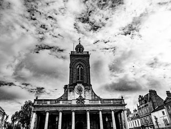 Low angle view of building against cloudy sky