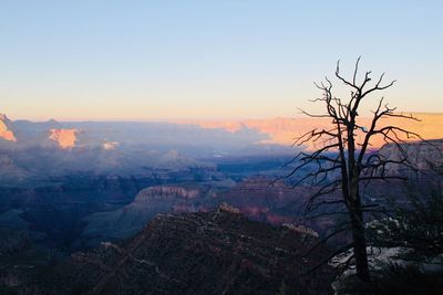 Scenic view of mountains against clear sky at sunset