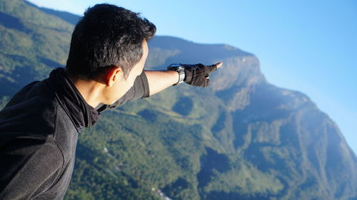 Midsection of man holding mountain