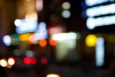 Defocused image of illuminated city at night