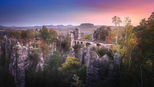 Panoramic view of trees and mountains against sky