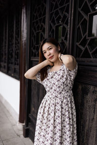 Portrait of beautiful young woman standing outdoors