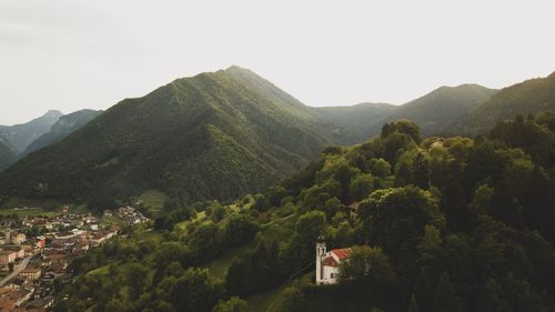 Scenic view of mountains and trees against clear sky