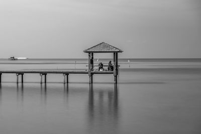 Lifeguard hut on beach against sky