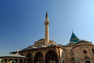 Low angle view of mosque against clear blue sky