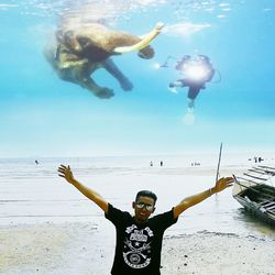 Man surfing in sea against sky