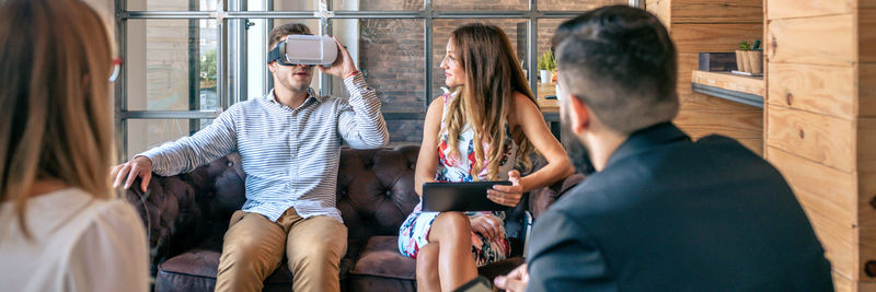 Top view of business people in an informal work meeting using virtual reality glasses