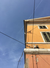 Low angle view of building against blue sky