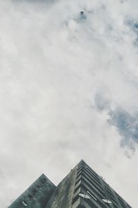 Low angle view of built structure against cloudy sky