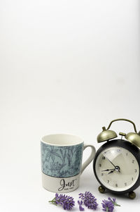 High angle view of clock on table against white background