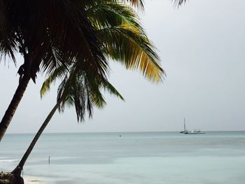 Lone boat in calm sea against clear sky