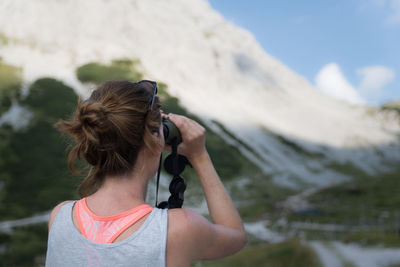 Rear view of woman photographing