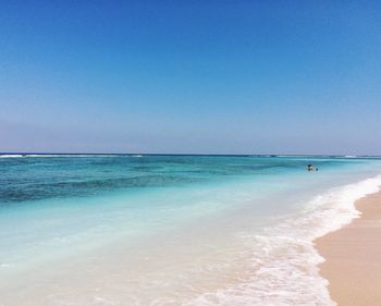 Scenic view of beach against clear sky