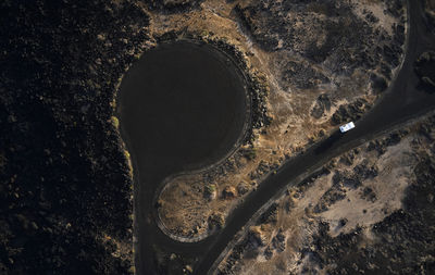 Spain, canary islands, aerial view of motor home driving along gravel road at lanzarote island