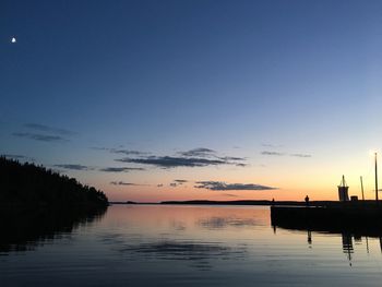 Scenic view of lake against sky at sunset