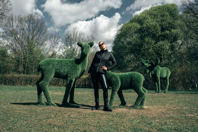 Side view of man riding horse on field