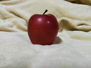 Close-up of apple on bed