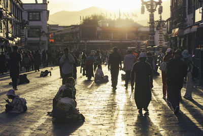 Rear view of people walking on street