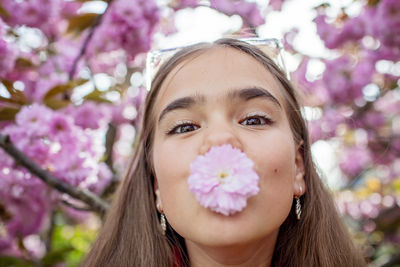 Portrait of young woman holding flower