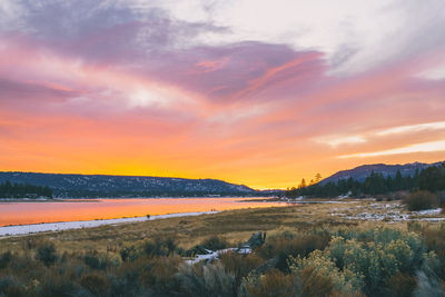 Scenic view of lake against sky during sunset