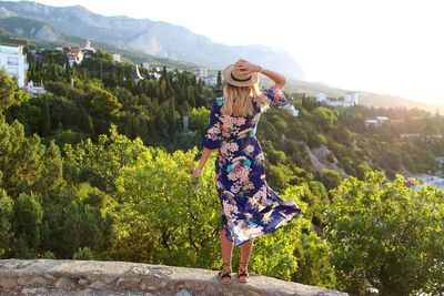 Rear view of woman standing on mountain