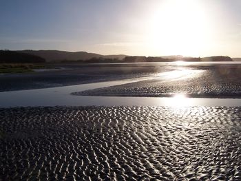 Scenic view of beach against sky during sunset
