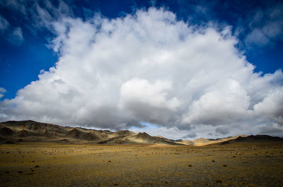 Scenic view of arid landscape against sky