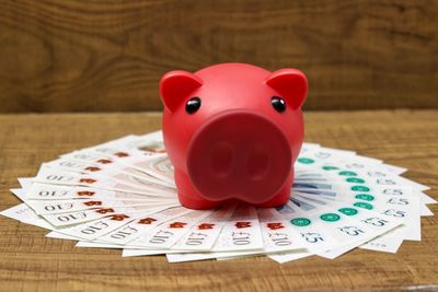 Close-up of red piggy bank on paper currencies