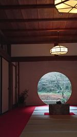 Close-up of illuminated lamp on table at home