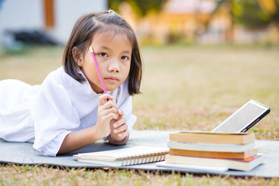 Portrait of a girl with book on table