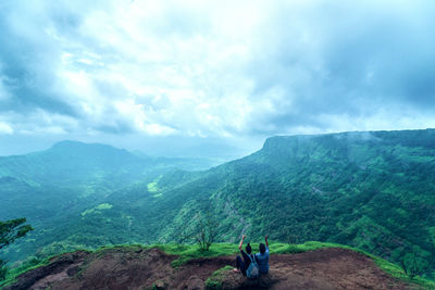 Couple overlooking lush landscape