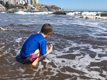 Rear view of boy on beach