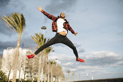 Spain, young man jumping in the air