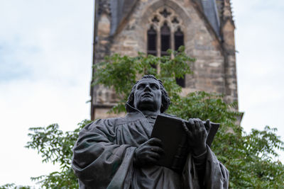 Low angle view of statue against sky