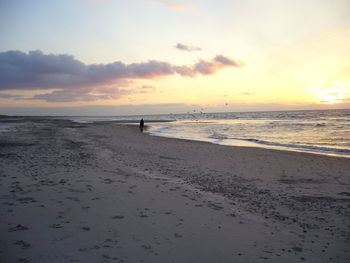 View of calm beach at sunset
