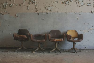 Empty chairs against wall