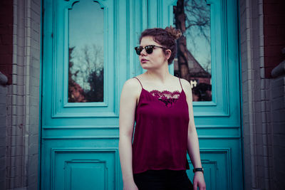 Portrait of woman wearing sunglasses standing outdoors