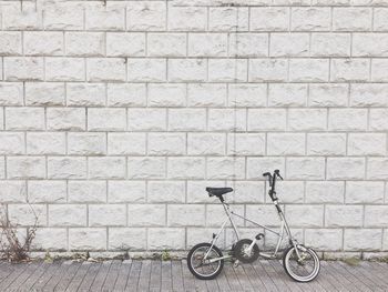 Bicycle parked against wall