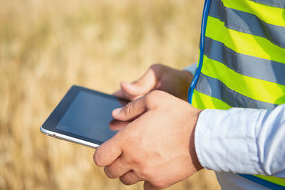 Midsection of woman using mobile phone