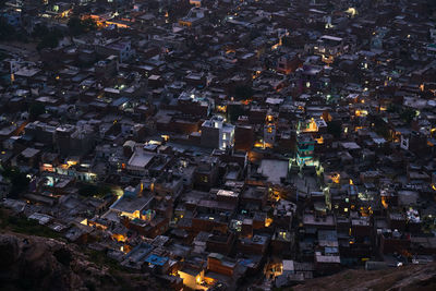 High angle view of city lit up at night