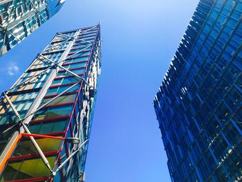 Low angle view of skyscrapers against clear blue sky