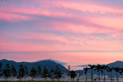 Scenic view of silhouette mountains against sky at sunset