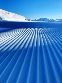 Scenic view of snowcapped mountain against blue sky