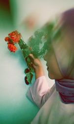 Close-up of woman holding flower bouquet