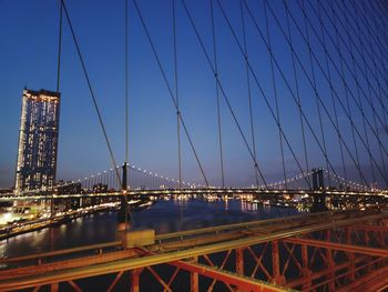 View of suspension bridge against cloudy sky