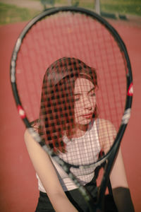 Midsection of woman holding red ball