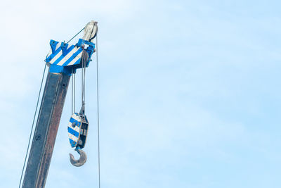 Low angle view of ferris wheel against blue sky