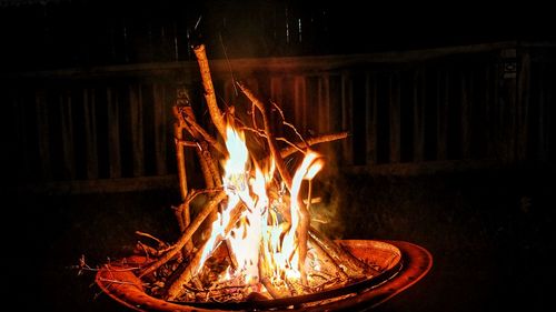 Bonfire on wooden structure at night