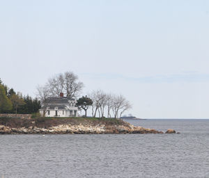 Scenic view of sea by building against clear sky