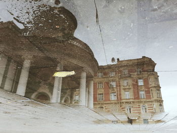 Low angle view of old building against sky during winter